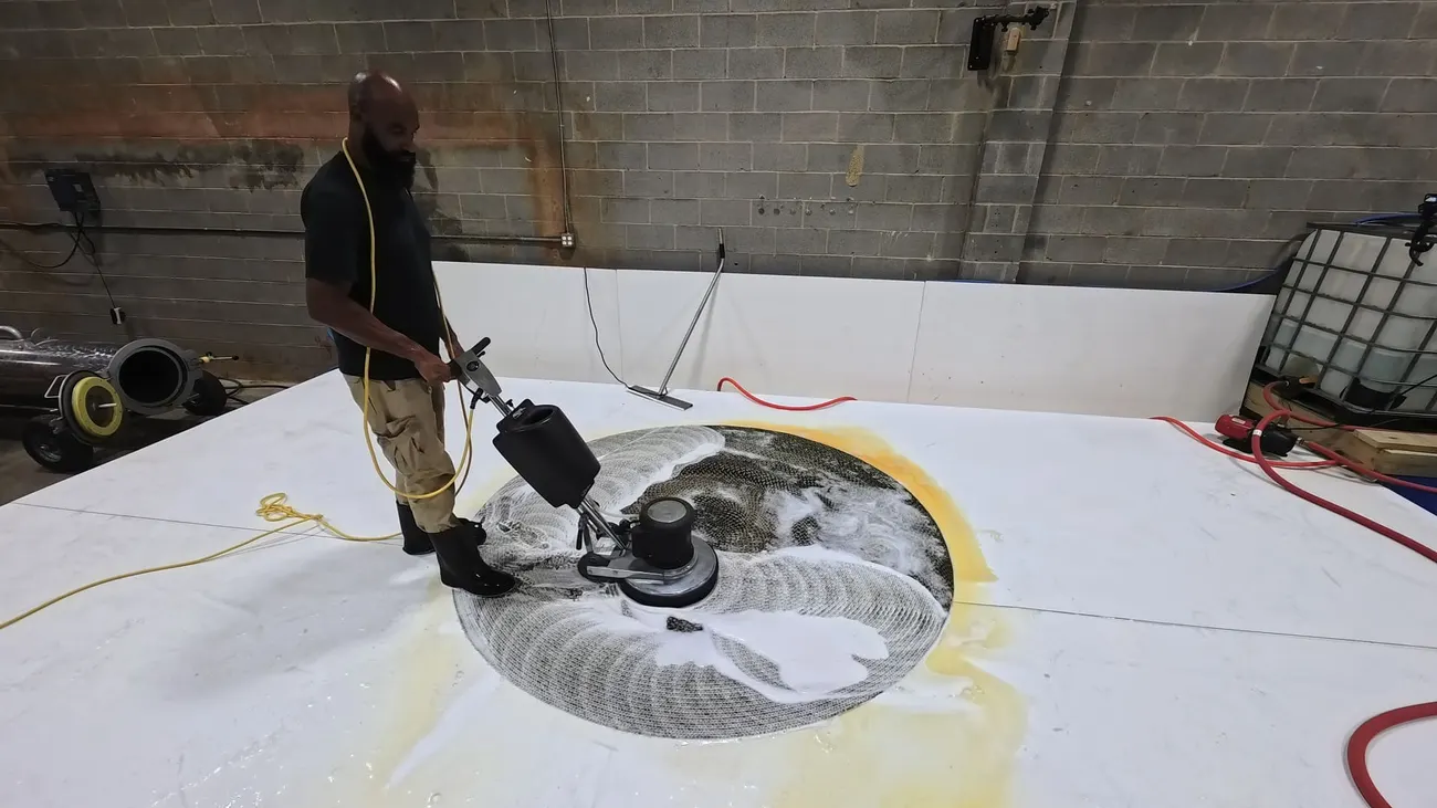 A Total Cleaning Service technician hand-washing a rug at our Springfield facility